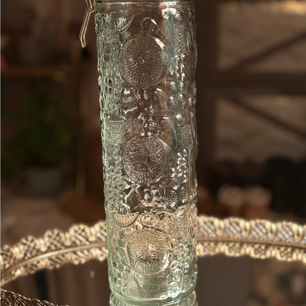Vintage style glass canister featuring an embossed fruit design